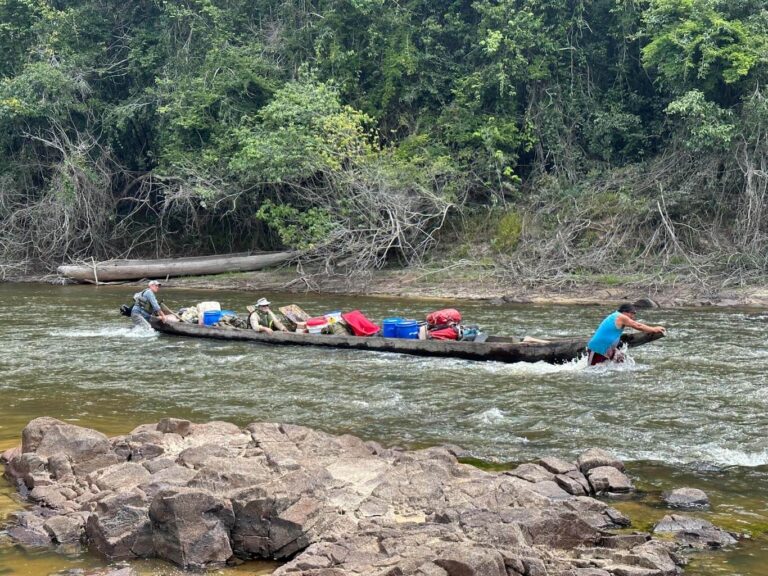 pushing boats through jungle river